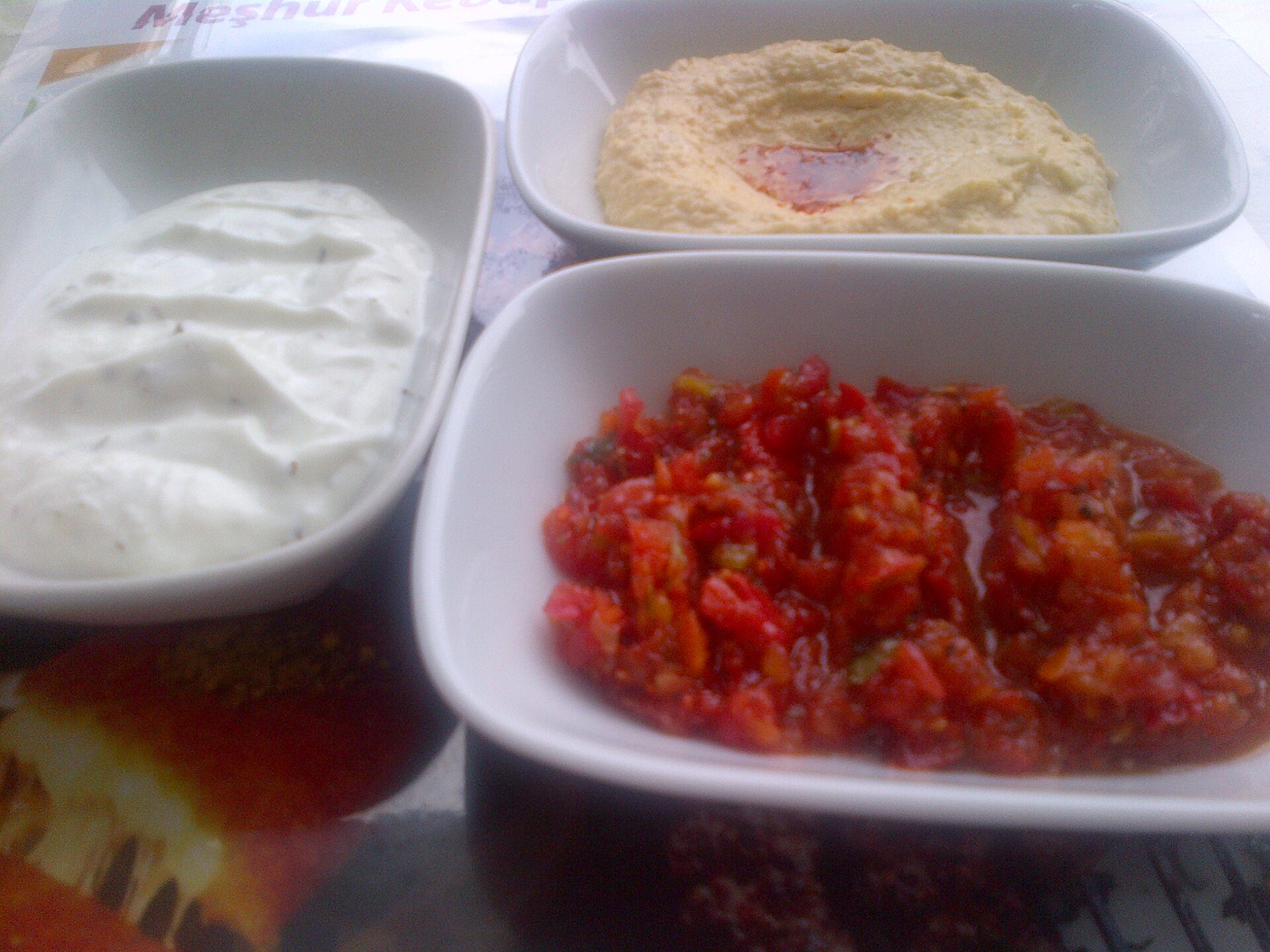 Hummus, ezme, haydari — the cold side of a platter, not a supermarket tub.